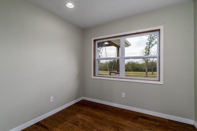 spare room featuring dark wood-type flooring