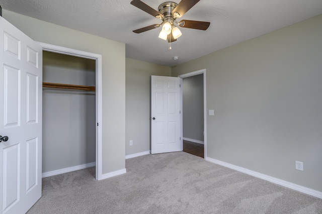 unfurnished bedroom with light carpet, ceiling fan, and a closet