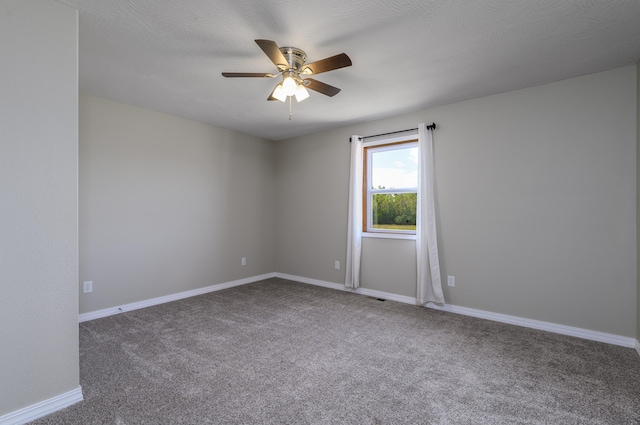 carpeted spare room featuring a textured ceiling and ceiling fan