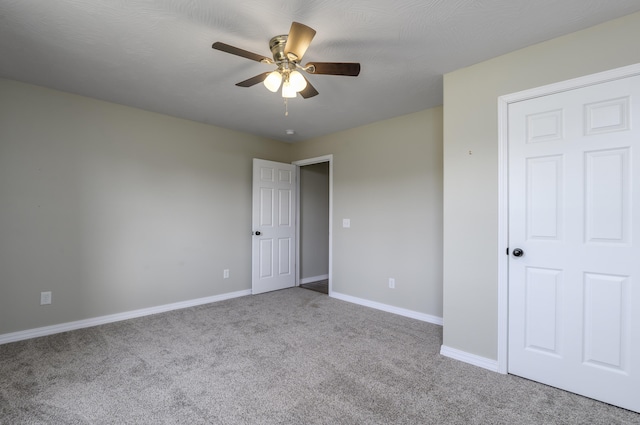 unfurnished bedroom featuring ceiling fan and light carpet