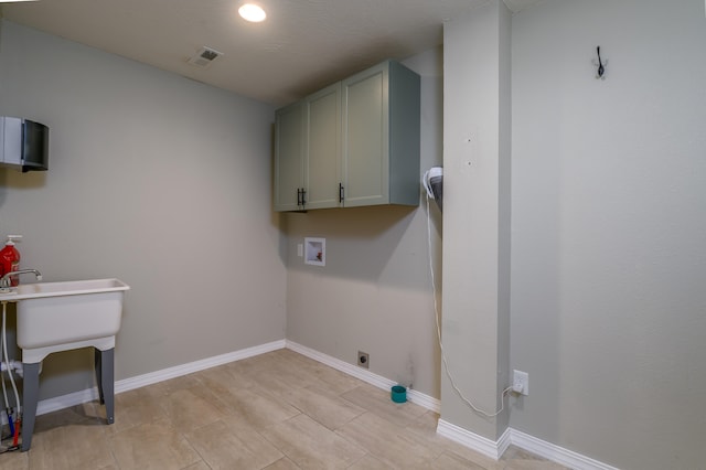 laundry room with hookup for a washing machine and cabinets