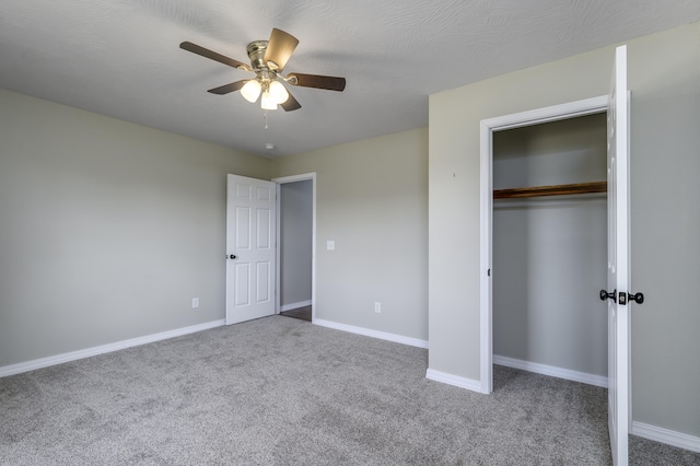 unfurnished bedroom featuring ceiling fan, a closet, and carpet