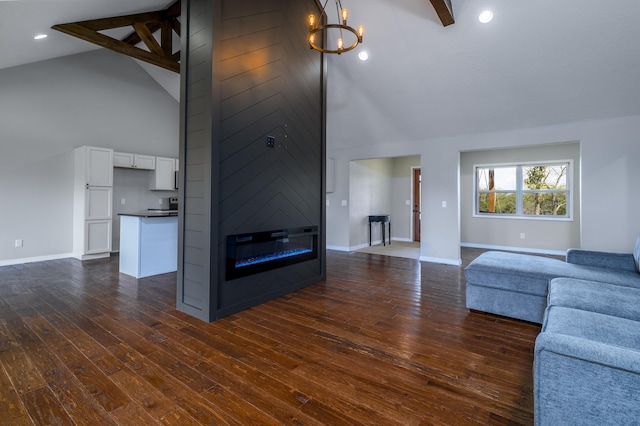 unfurnished living room with high vaulted ceiling, beam ceiling, and dark hardwood / wood-style floors