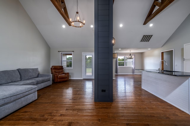 living room with dark hardwood / wood-style floors, high vaulted ceiling, beamed ceiling, and a healthy amount of sunlight