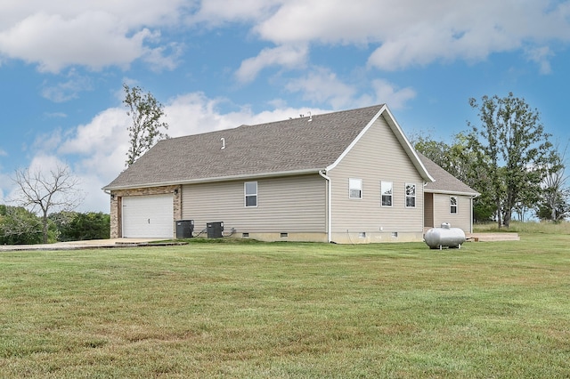 view of home's exterior featuring a garage, a lawn, and central AC