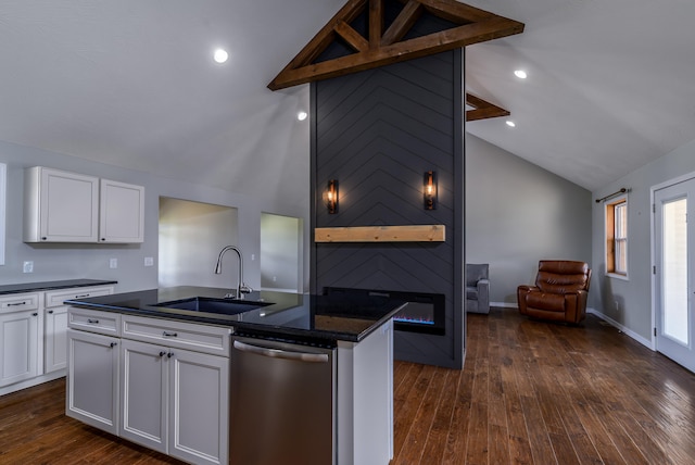 kitchen with dark hardwood / wood-style floors, sink, an island with sink, stainless steel dishwasher, and white cabinetry