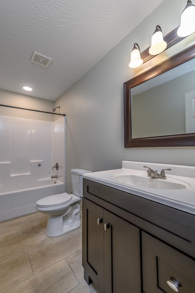 full bathroom featuring toilet, tile patterned floors, vanity, shower / tub combination, and a textured ceiling