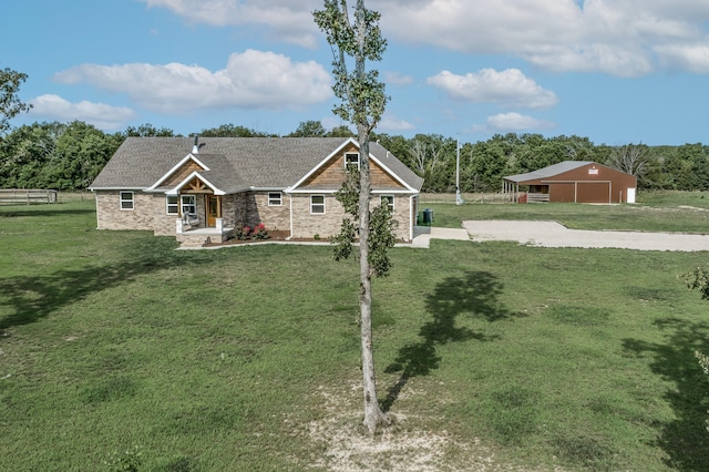 craftsman inspired home featuring an outbuilding and a front yard