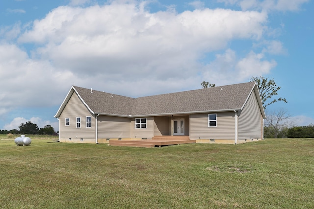 back of property featuring a lawn and a deck