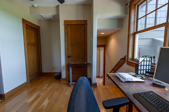 home office with ceiling fan and light wood-type flooring