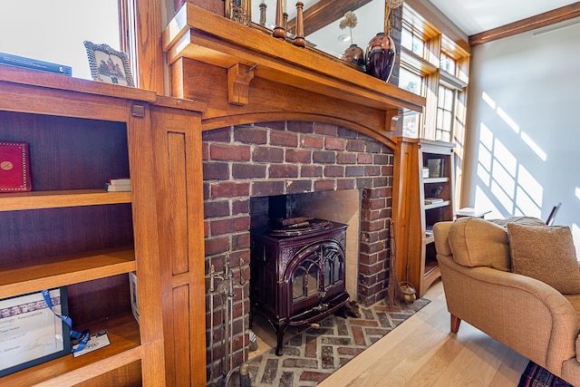 living room with a wood stove, hardwood / wood-style flooring, beamed ceiling, and a towering ceiling