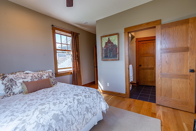 bedroom with ceiling fan and dark hardwood / wood-style flooring