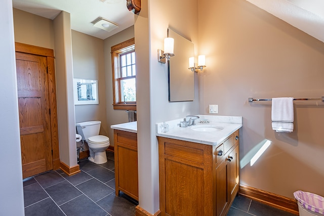 bathroom with vanity, toilet, and tile patterned floors