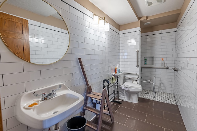 bathroom with toilet, sink, tile walls, tile patterned flooring, and decorative backsplash