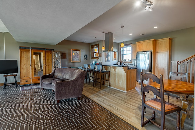 living room featuring a textured ceiling and hardwood / wood-style floors