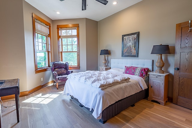 bedroom with light hardwood / wood-style floors and ceiling fan