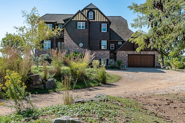 tudor house featuring a garage