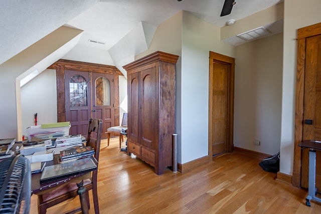 foyer entrance with lofted ceiling, light hardwood / wood-style floors, and ceiling fan