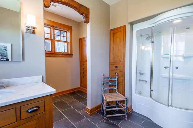 bathroom with tile patterned floors, vanity, and enclosed tub / shower combo