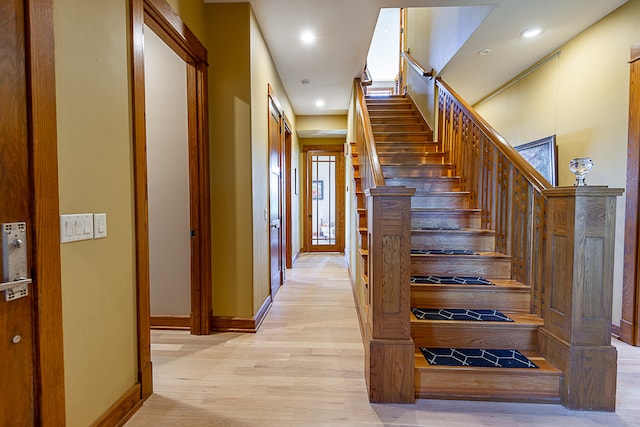 stairway with hardwood / wood-style flooring