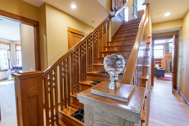 stairway with hardwood / wood-style floors