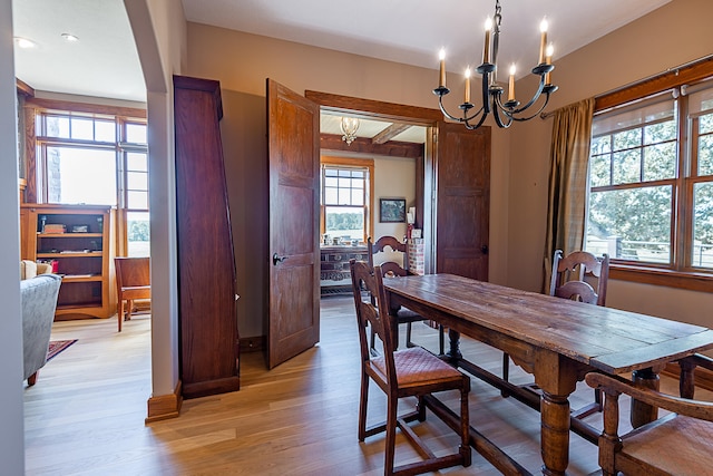 dining area with a chandelier and light hardwood / wood-style floors