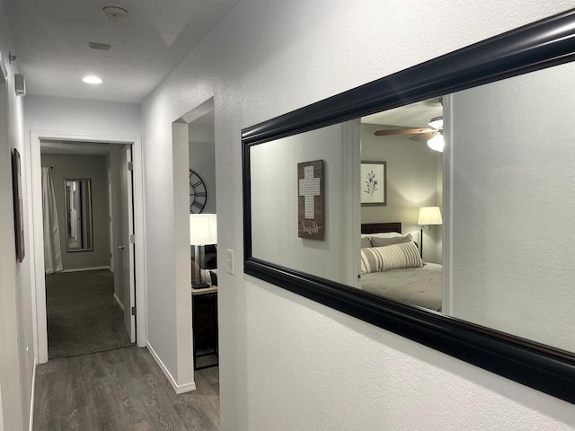 hallway with hardwood / wood-style flooring