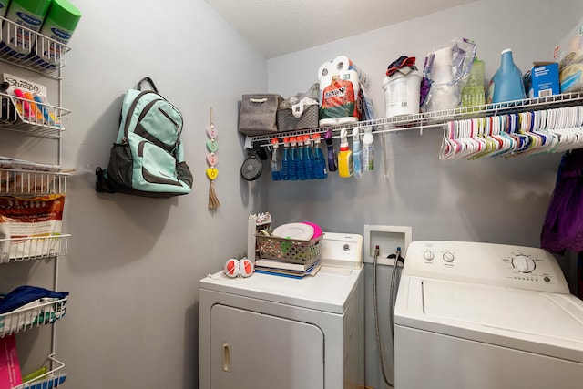 washroom featuring washer and dryer and a textured ceiling