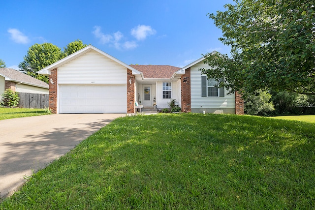 ranch-style house featuring a garage and a front lawn