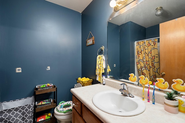 bathroom featuring vanity and toilet