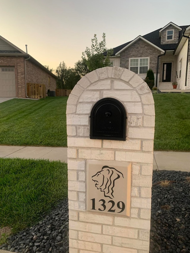 community / neighborhood sign with a lawn