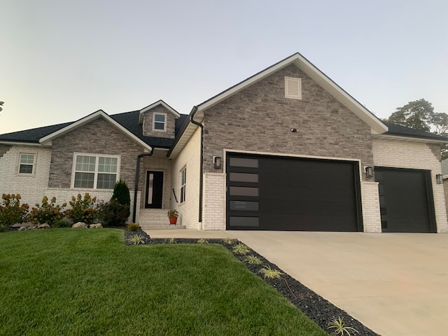 view of front of property with a garage and a front lawn