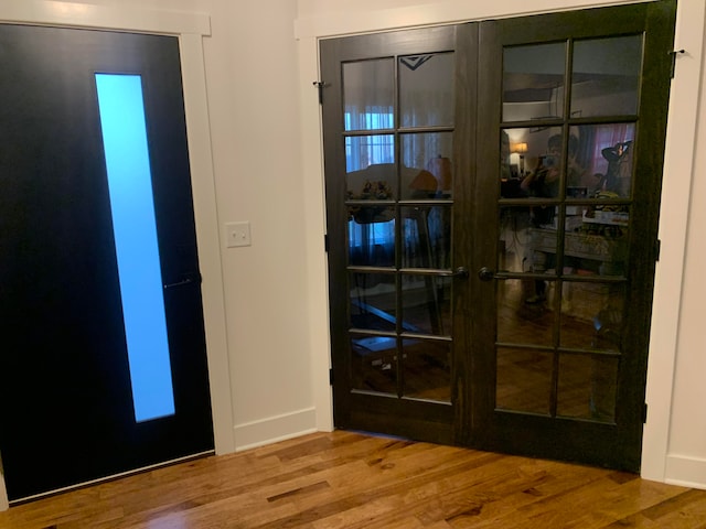 foyer with hardwood / wood-style floors and french doors