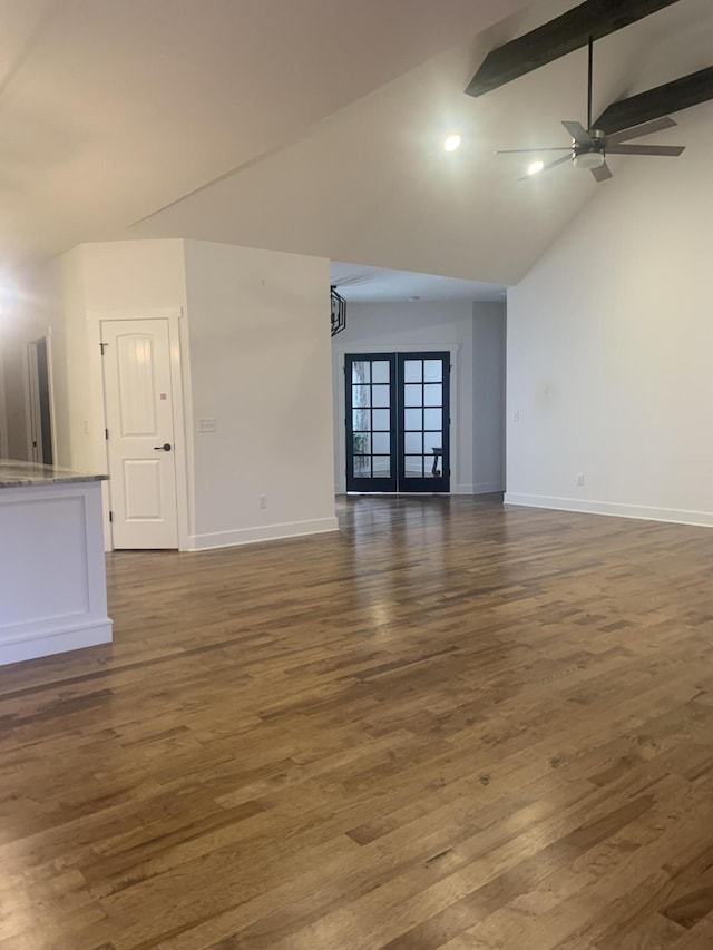 unfurnished living room featuring high vaulted ceiling, french doors, dark hardwood / wood-style floors, ceiling fan, and beam ceiling