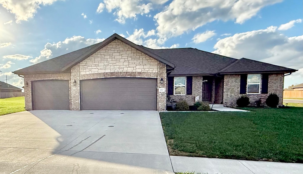 view of front of property with a garage and a front yard