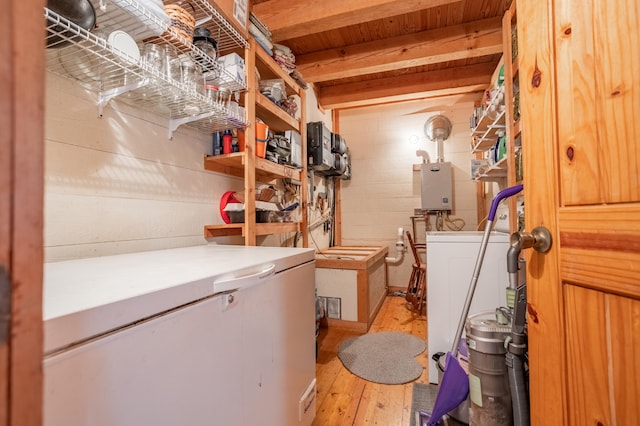 storage area with washer / dryer and tankless water heater