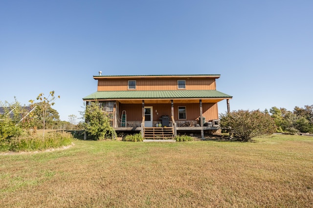 exterior space featuring a lawn and covered porch