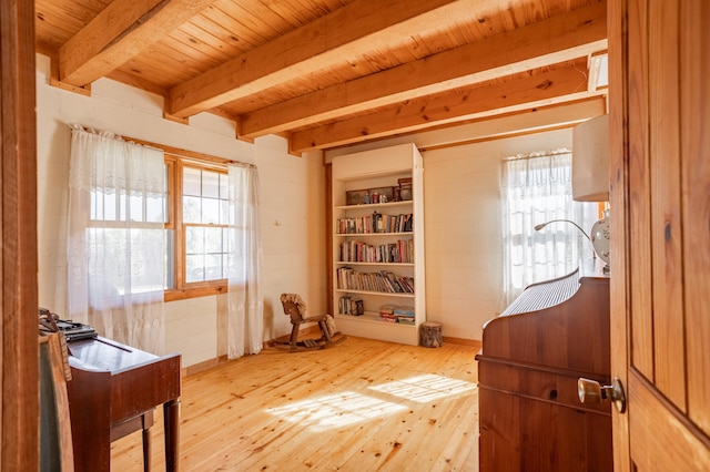 living area featuring wood ceiling, hardwood / wood-style flooring, and beamed ceiling