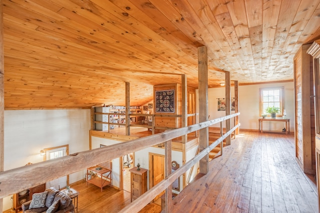 hallway featuring wood-type flooring, lofted ceiling, and wooden ceiling