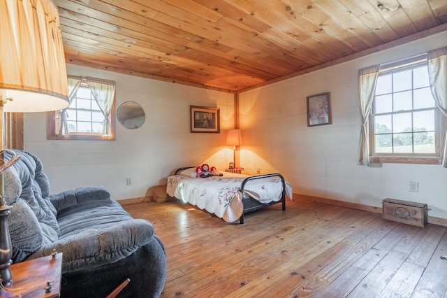 bedroom with light hardwood / wood-style flooring and wooden ceiling