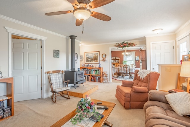 living room featuring carpet floors, ornamental molding, a wood stove, and a wealth of natural light