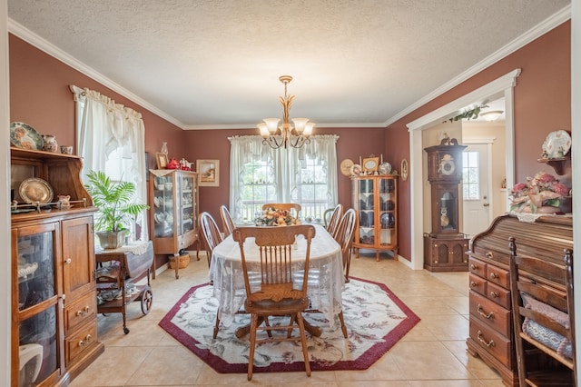 tiled dining room featuring ornamental molding, plenty of natural light, and a chandelier