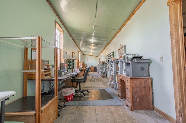 office with light hardwood / wood-style floors and vaulted ceiling