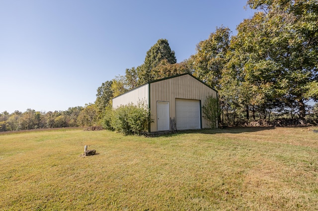 view of outdoor structure with a lawn and a garage