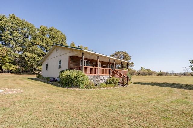 view of front of home with a wooden deck and a front lawn