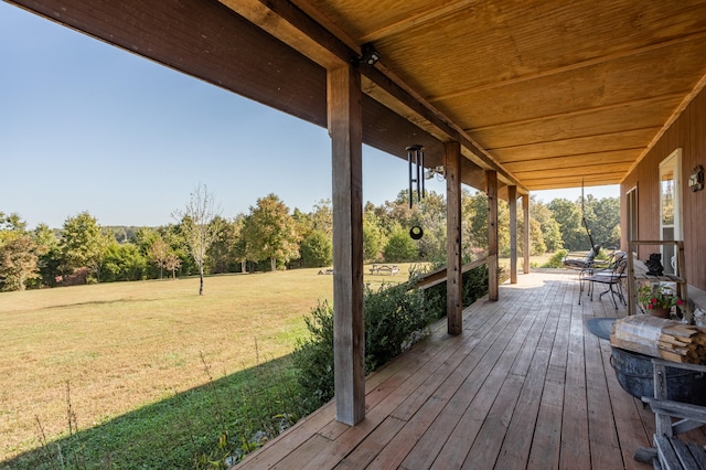 wooden terrace with a lawn