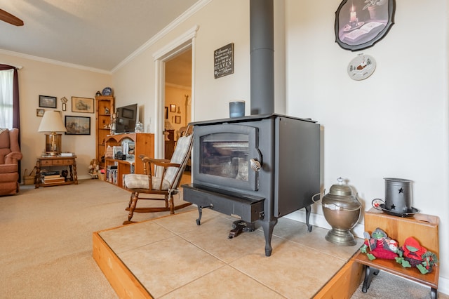 living area featuring a wood stove, ornamental molding, and carpet flooring