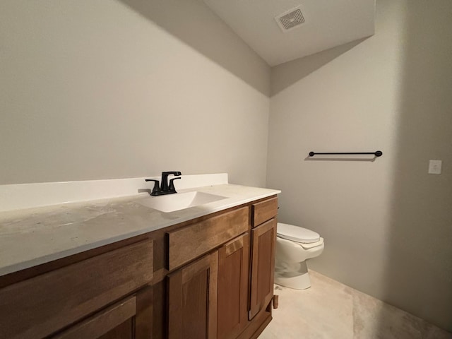 bathroom with vanity, toilet, and tile patterned flooring