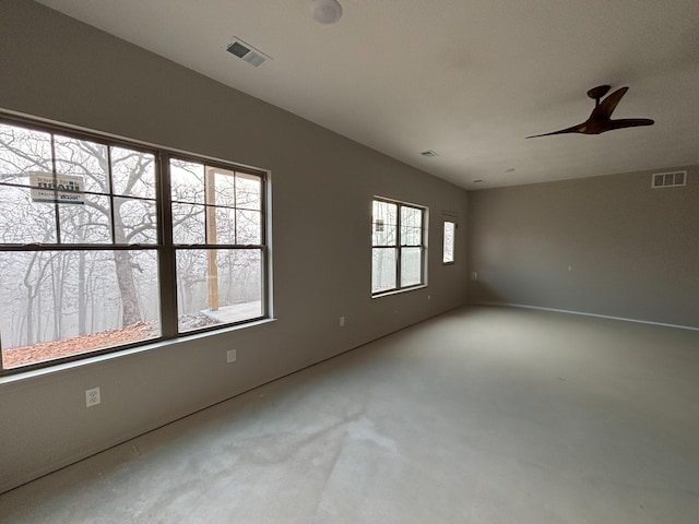 spare room featuring a wealth of natural light and ceiling fan