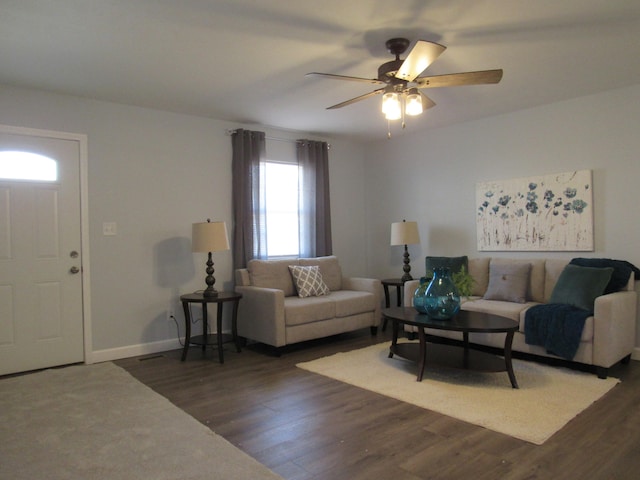 living room featuring ceiling fan and dark hardwood / wood-style floors